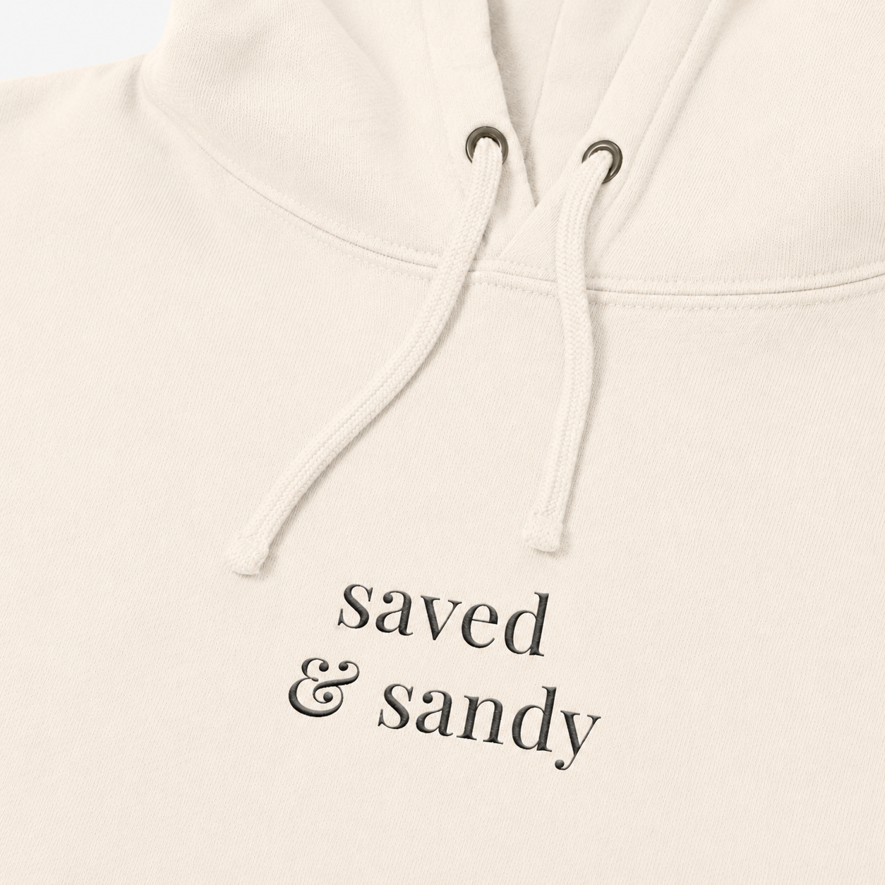 Close-up of Saved and Sandy center chest hoodie embroidery